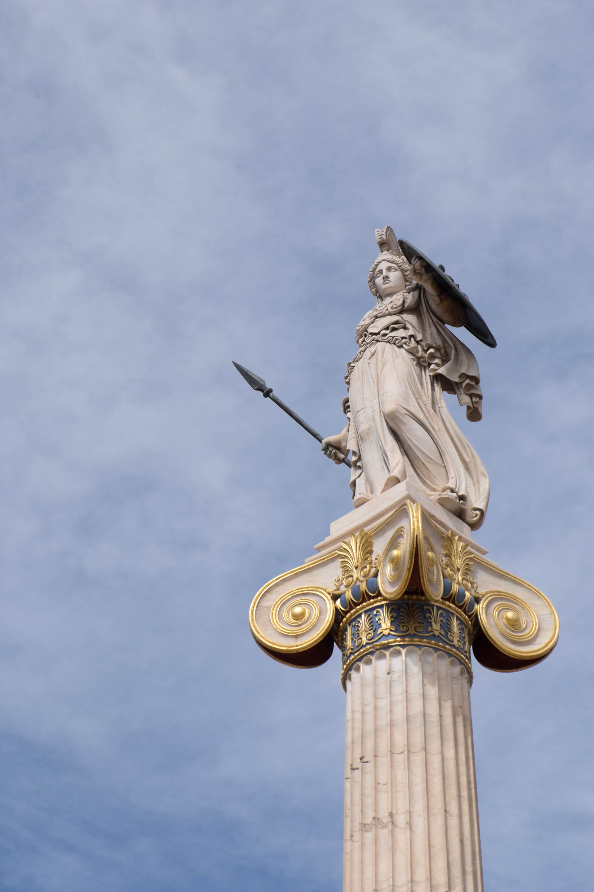 Marble statue of Athena bearing a spear and shield atop a gilded Ionic column