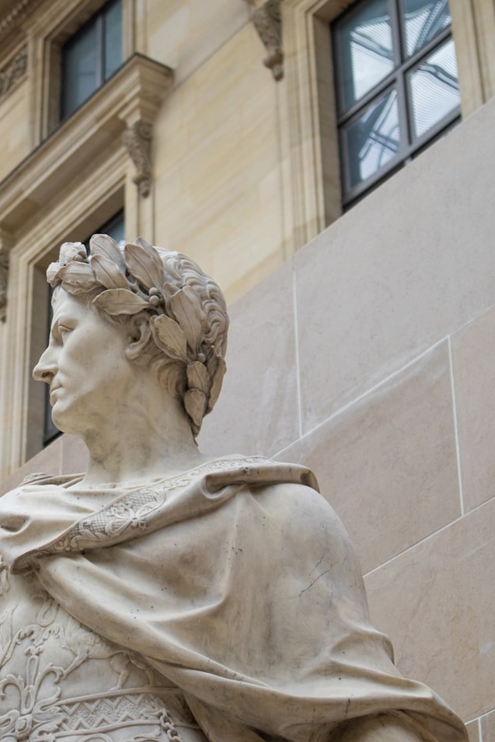 Marble statue of a laurel-crowned Roman emperor in profile